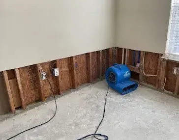 Drywall cut away along the bottom of a wall so the cavity can dry out