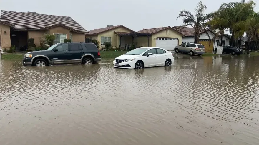 Floodwater filling a residential street after a long stretch of heavy rain